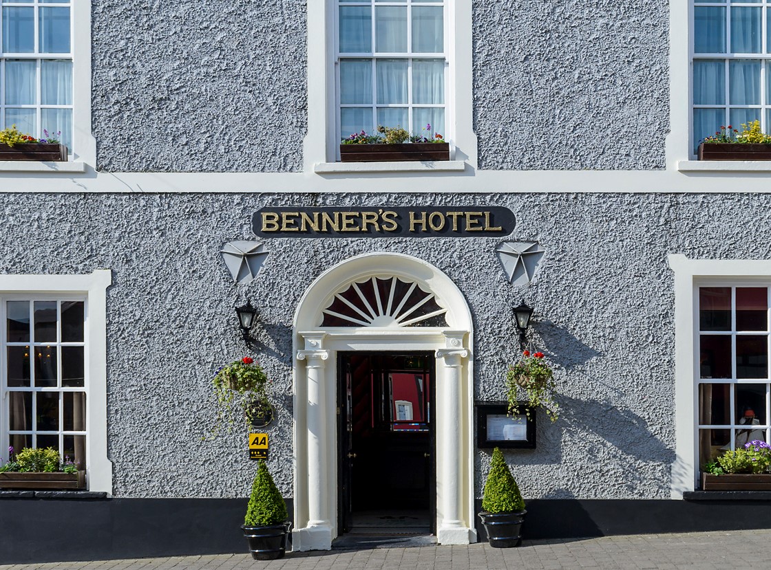 Dingle Benners Hotel, Dingle — grey stone façade and arched entrance with the Benner's Hotel sign