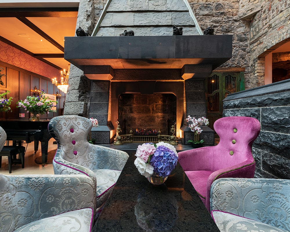 Clontarf Castle Hotel, Dublin — lobby lounge with grand stone fireplace