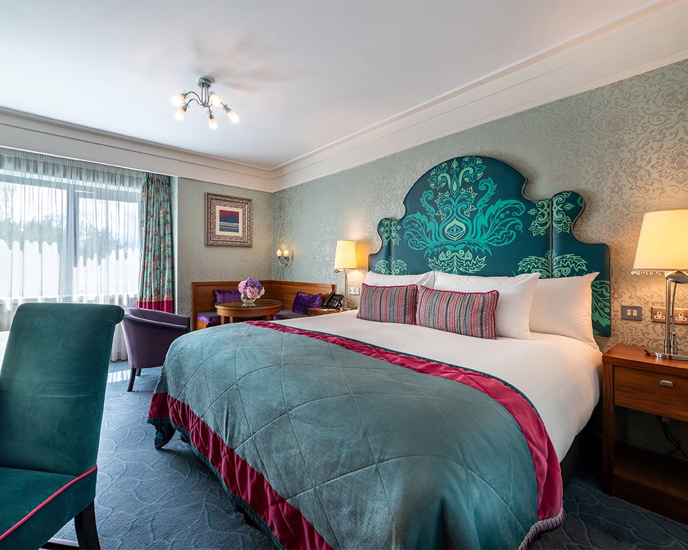 Clontarf Castle Hotel, Dublin — deluxe guest room with king bed