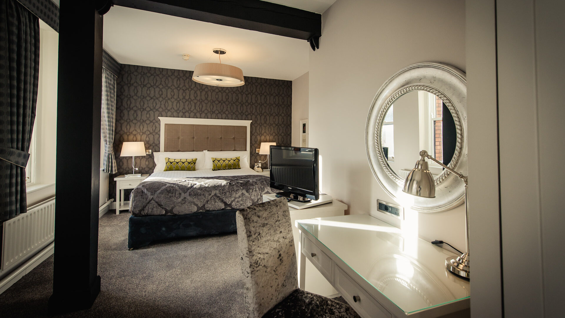 Hotel Isaacs Cork — deluxe guest room with original period features and exposed stonework