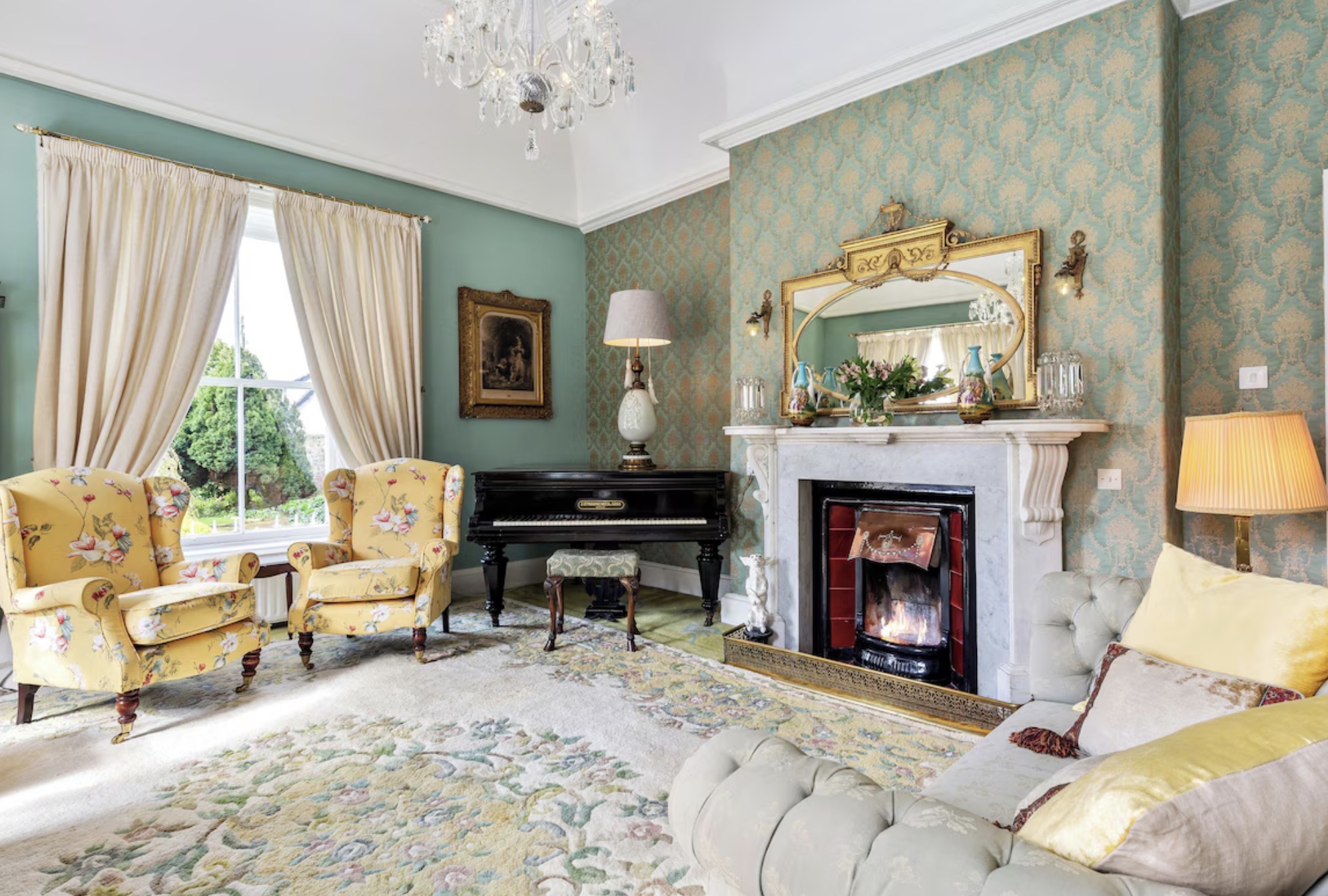 Sitting room with grand piano & fireplace